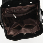 Black handbag with open interior showing brown lining and zippers.