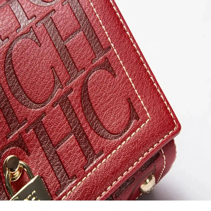Red handbag with 'CHIC' text on a white background