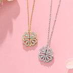 Two butterfly-shaped pendants on gold and silver chains against a pink background