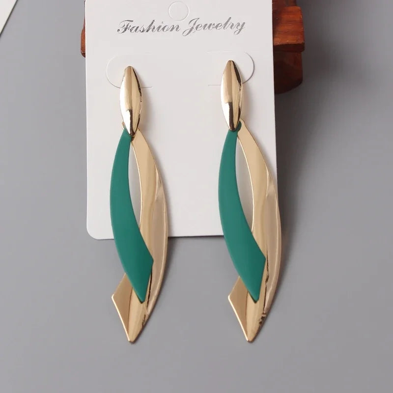 Gold and green earrings on a gray background with 'Fashion Jewelry' label.