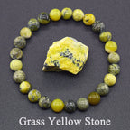 Stones arranged in a circle with a yellow stone in the center on a dark background