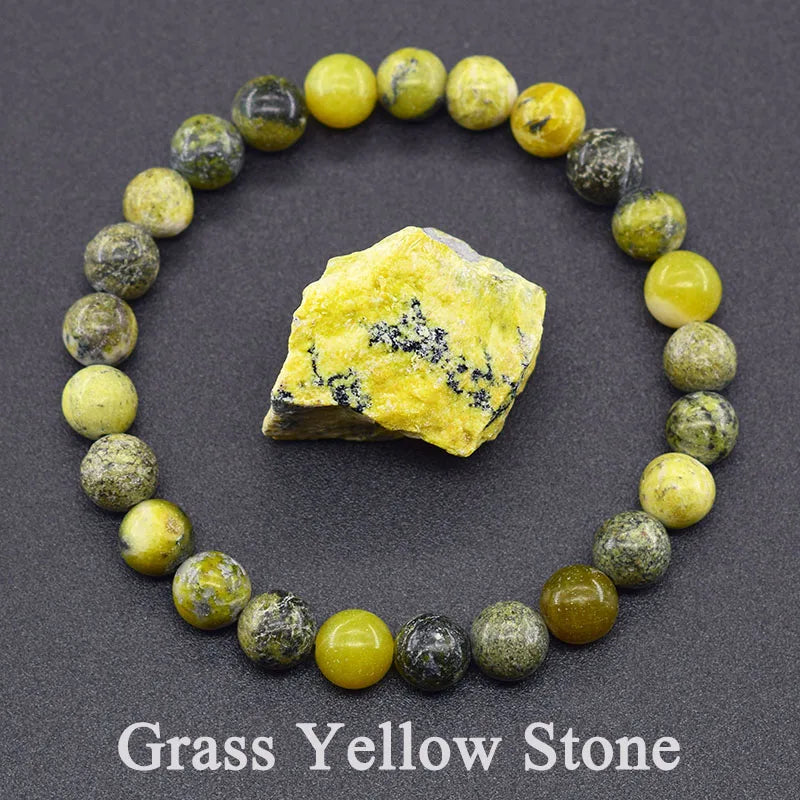 Stones arranged in a circle with a yellow stone in the center on a dark background