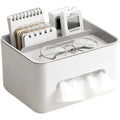 White desk organizer with glasses, notepad, and small device on a white background