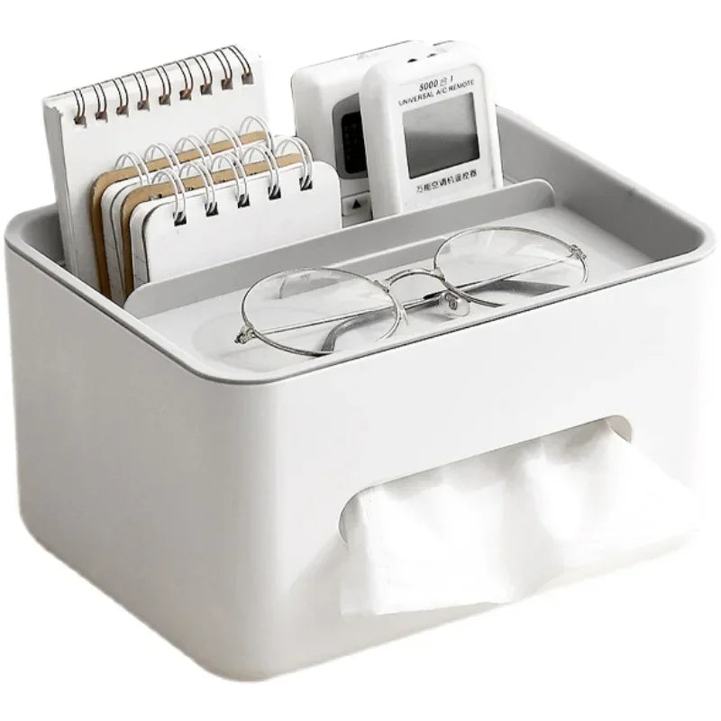 White desk organizer with glasses, notepad, and small device on a white background