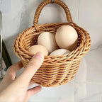 Wicker basket with eggs held by a hand on a tiled wall background