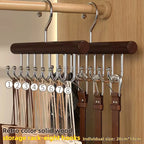 Wooden belt rack with eight hooks holding belts against a wooden background