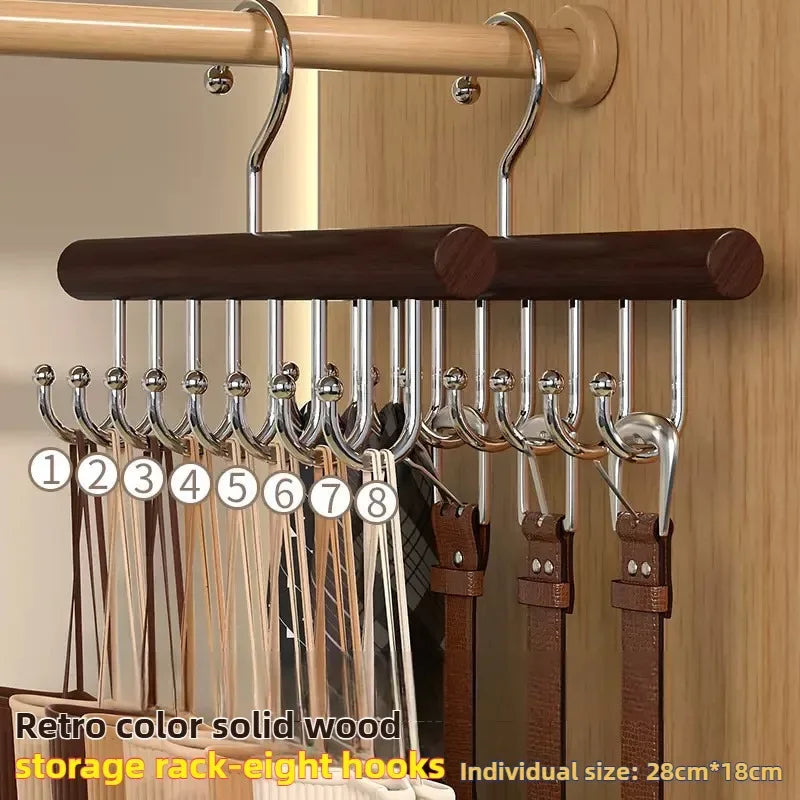 Wooden belt rack with eight hooks holding belts against a wooden background