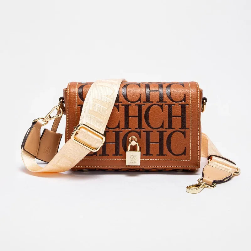 Brown handbag with beige strap and 'CHC' branding on a white background