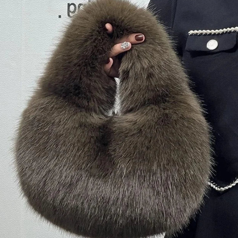 Brown fur scarf held by a person against a light gray background