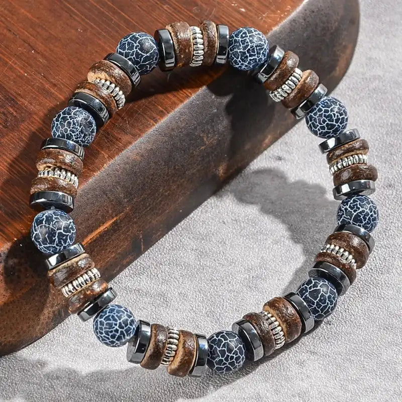 Bracelet with blue and brown beads on a wooden surface