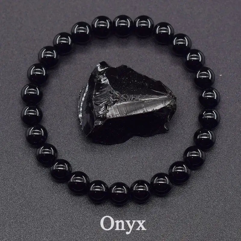 Black onyx bracelet with a raw onyx stone on a dark background
