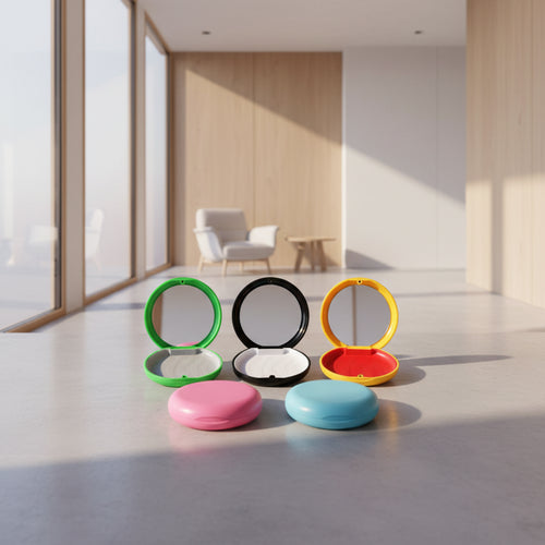 Set of colorful round mirrors with open and closed lids on a white background