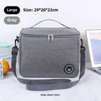 Gray insulated lunch bag with strap on a white surface, showing size and material details.