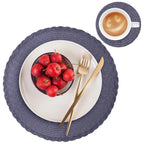 Table setting with blue placemats, red apples, gold fork and knife, and a cup of coffee.
