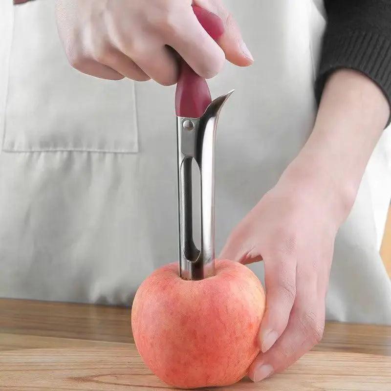 Person using a fruit peeler on an apple with a neutral background