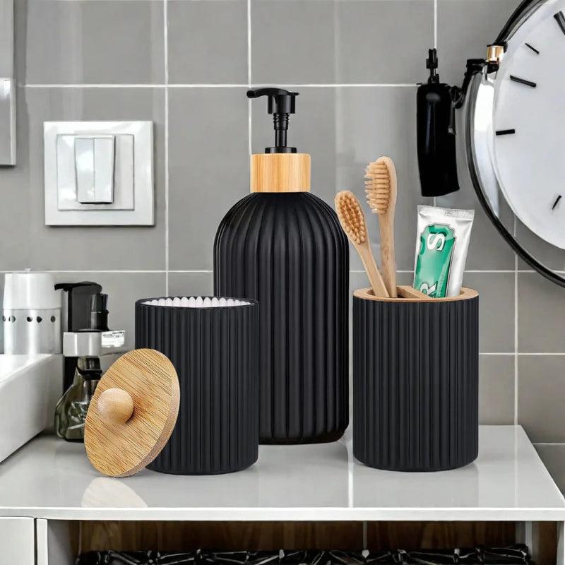 Black bathroom accessories set on a counter with a clock in the background