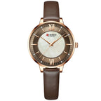 Curren watch with brown leather strap and rose gold casing on a white background