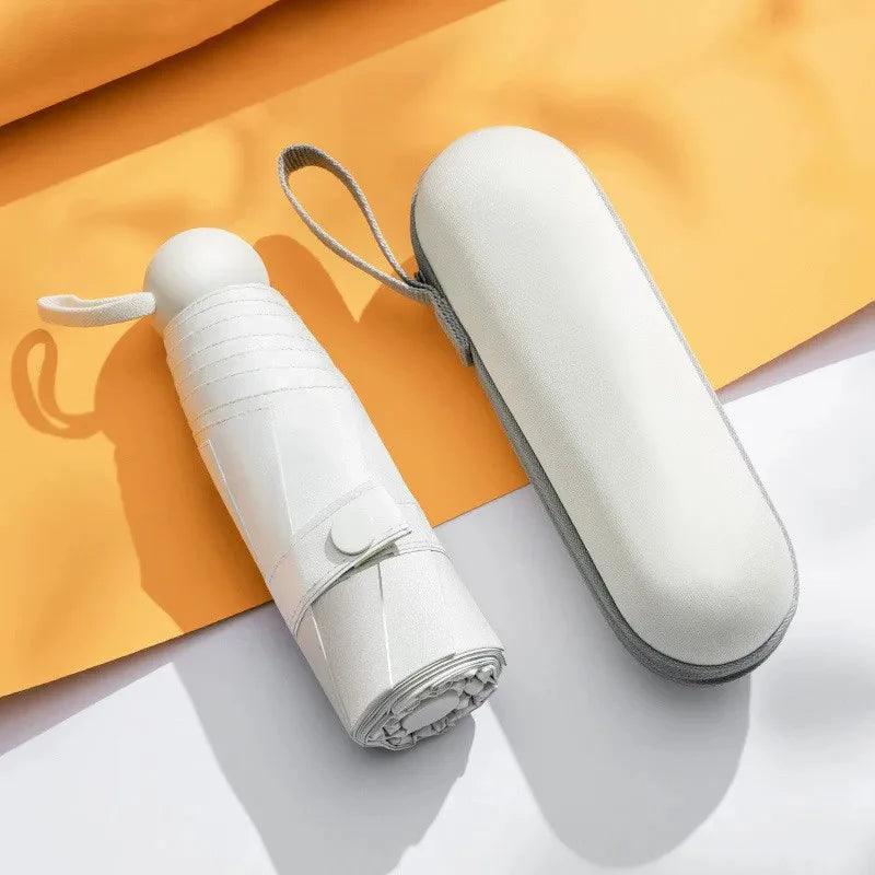 White umbrella and its carrying case on a yellow and white background