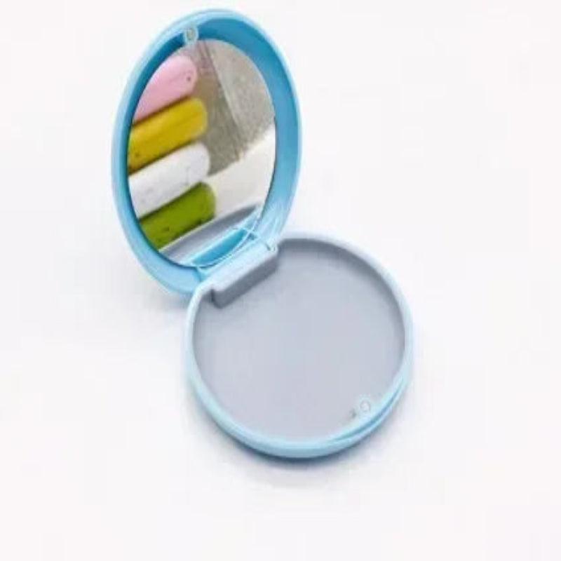 Compact mirror with colorful cotton swabs on a white background