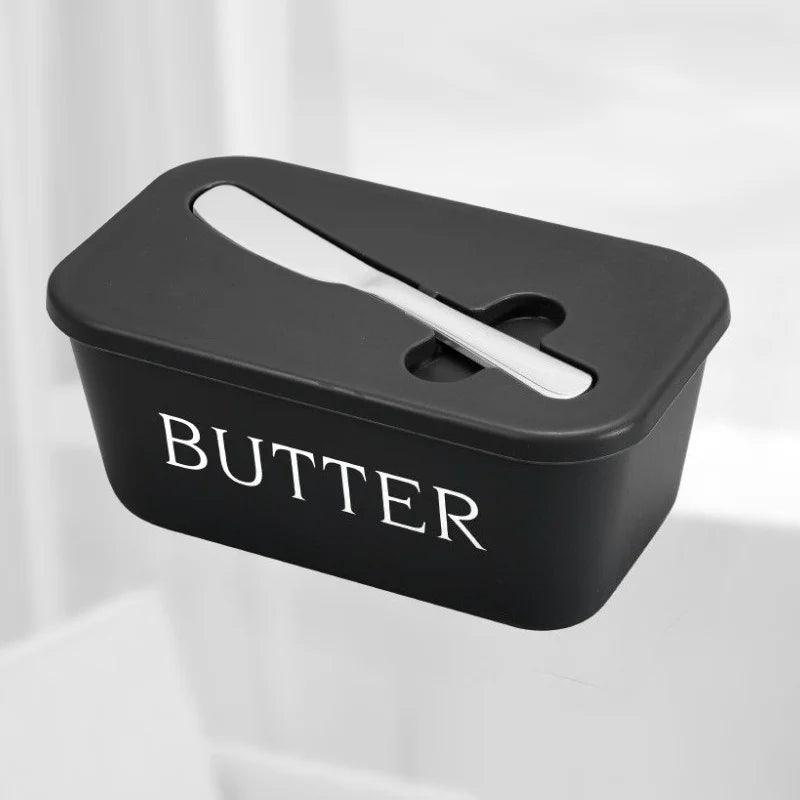 Black butter container with a white label on a light gray background