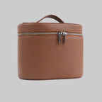 Brown leather travel case with a zipper on a white background