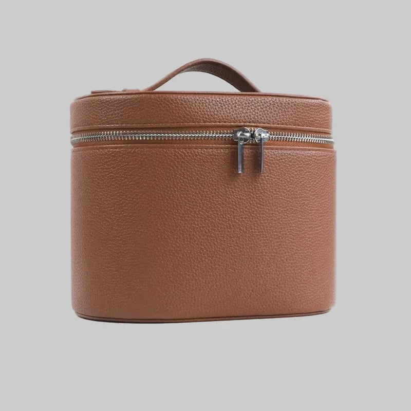 Brown leather travel case with a zipper on a white background