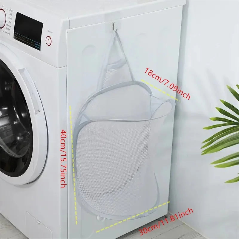 Gray mesh laundry bag with measurements in front of a washing machine