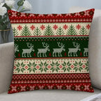 A square throw pillow with a festive Christmas knit pattern in red, green, and cream, resting on a light gray sofa.