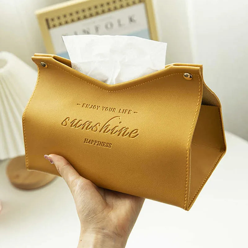 Yellow tissue holder with 'Enjoy your life, sunshine, happiness' text held by a hand.