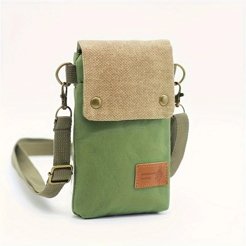 Green crossbody bag with beige top section on a white background