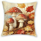 Square decorative throw pillow featuring a vintage-style illustration of three red-and-white spotted mushrooms surrounded by autumn leaves in warm beige, orange, and brown tones.