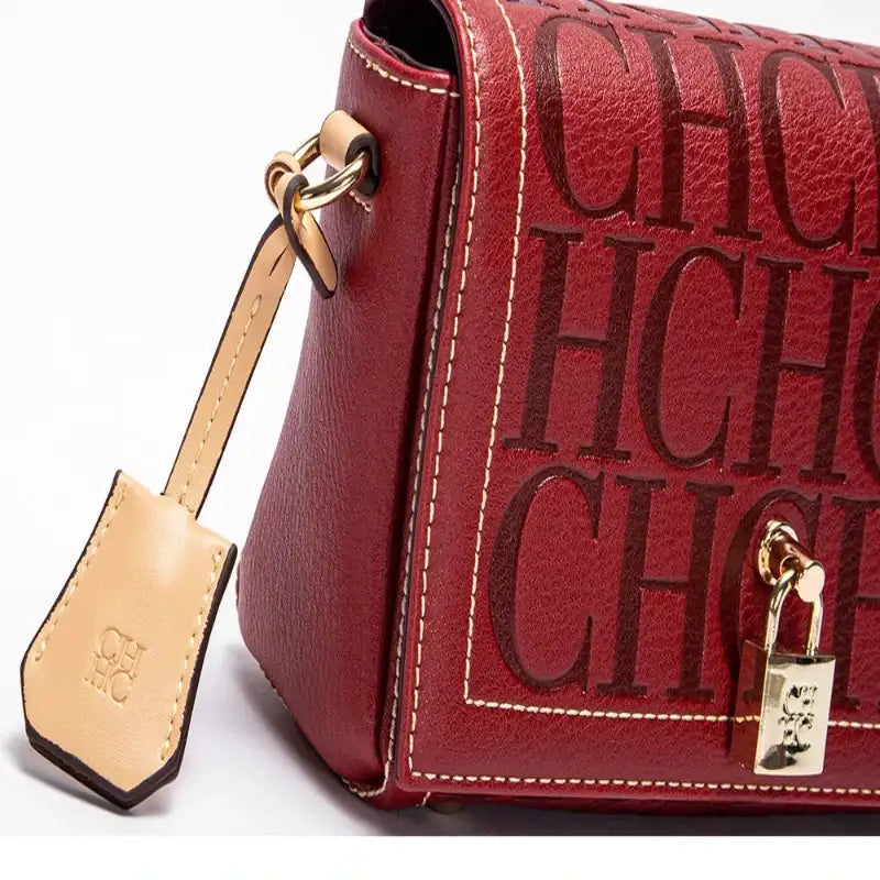 Red handbag with gold accents and 'CHIC' text on a white background