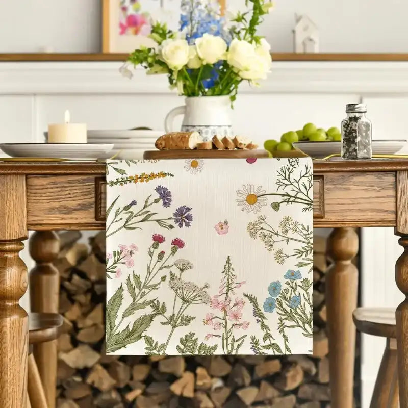 Floral-patterned towel hanging on a wooden table with a decorative background.
