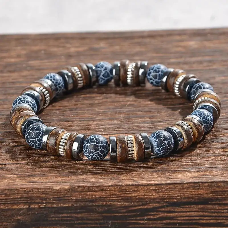 Bracelet with blue and brown beads on a wooden surface