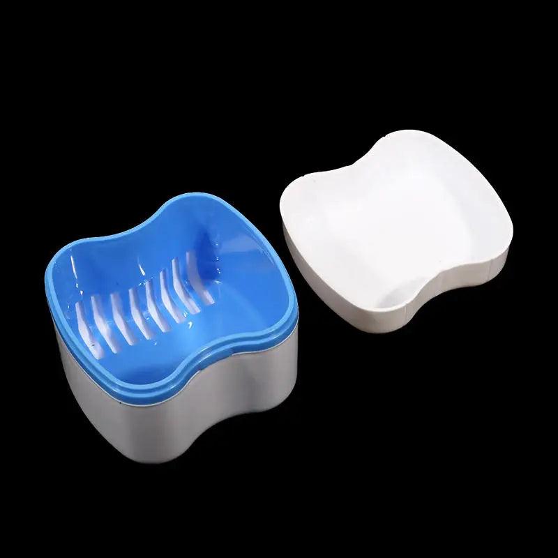 Two pet bowls, one blue and one white, on a black background
