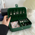 Green jewelry case with earrings and a hand holding it