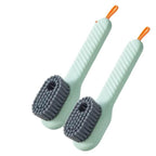 Two light green scrub brushes with gray bristles on a white background