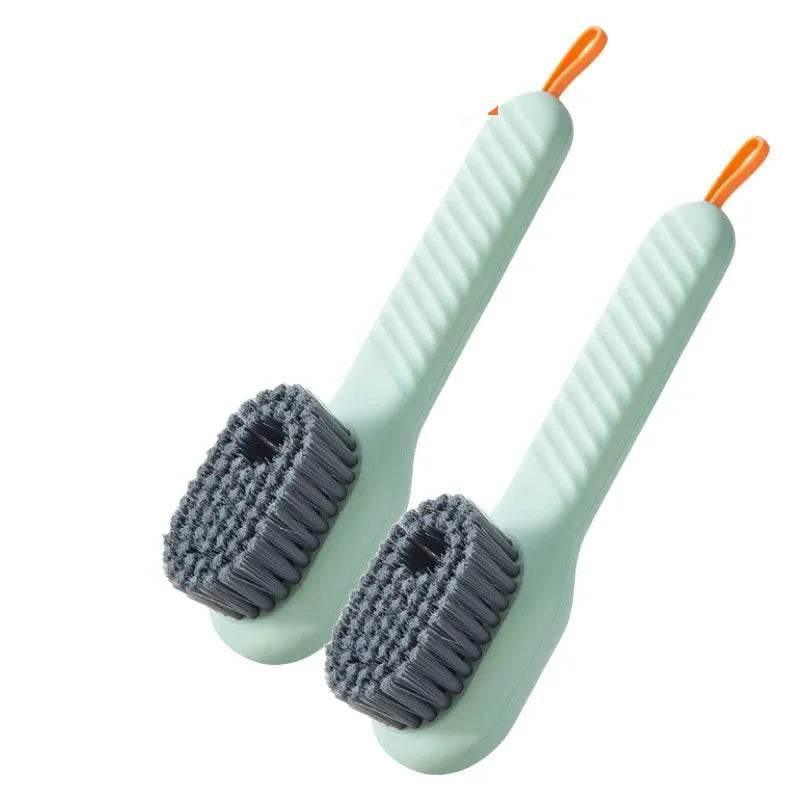 Two light green scrub brushes with gray bristles on a white background