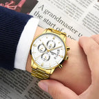 Gold wristwatch on a person's wrist with a newspaper background
