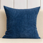 Blue textured pillow on a beige sofa