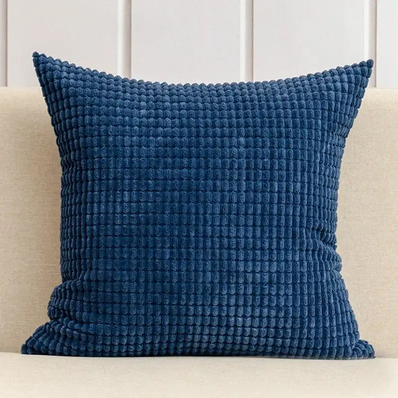 Blue textured pillow on a beige sofa