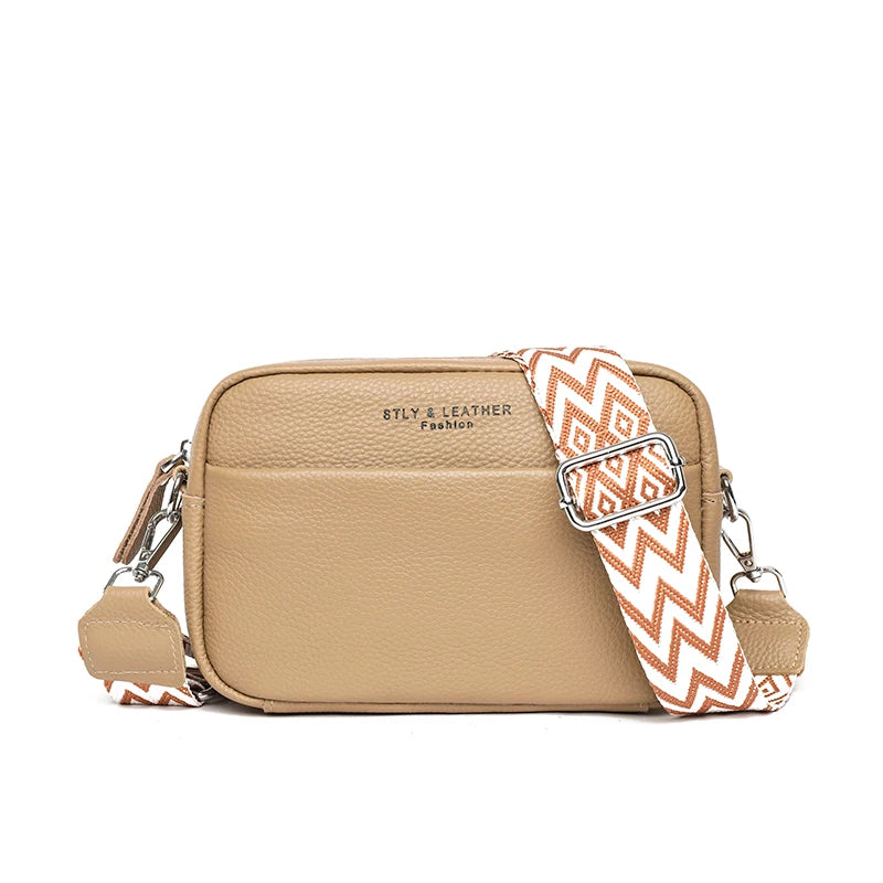 Beige crossbody bag with a patterned strap on a white background