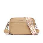Beige crossbody bag with a patterned strap on a white background