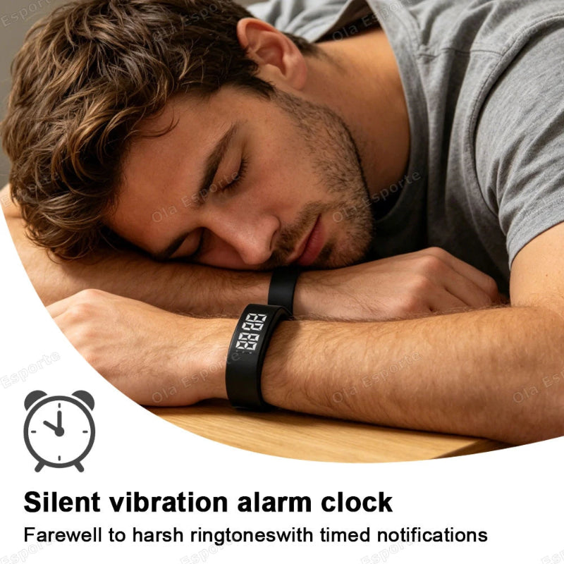 A man sleeping at a table wearing a black wristband alarm clock on his wrist. The image includes text overlays that read 'Silent vibration alarm clock' and 'Farewell to harsh ringtones with timed notifications'.