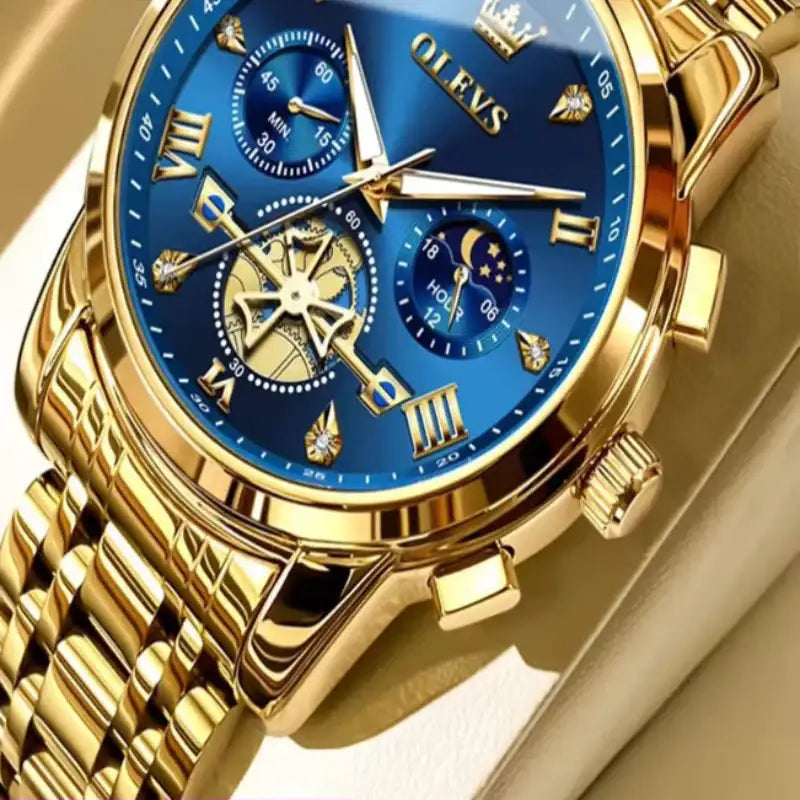 Gold wristwatch with blue face on a white background, featuring the OLEVS brand.