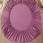 Purple fitted sheet on a bed with 'vave' brand logo.
