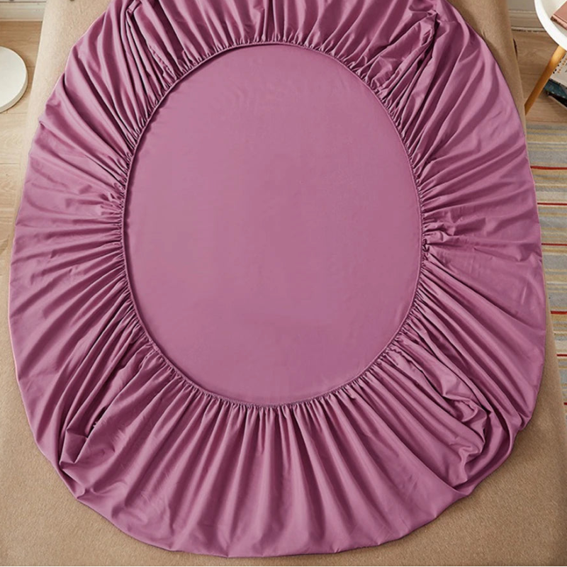 Purple fitted sheet on a bed with 'vave' brand logo.