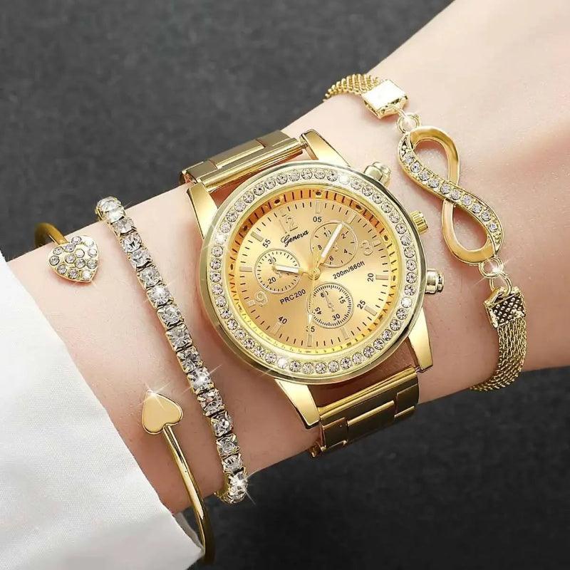 Gold watch and bracelets on a wrist against a dark background
