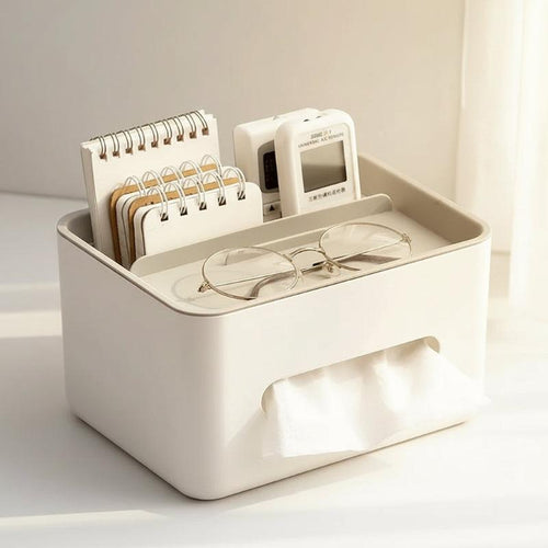 White desk organizer with glasses, notepads, and a digital device on a white background