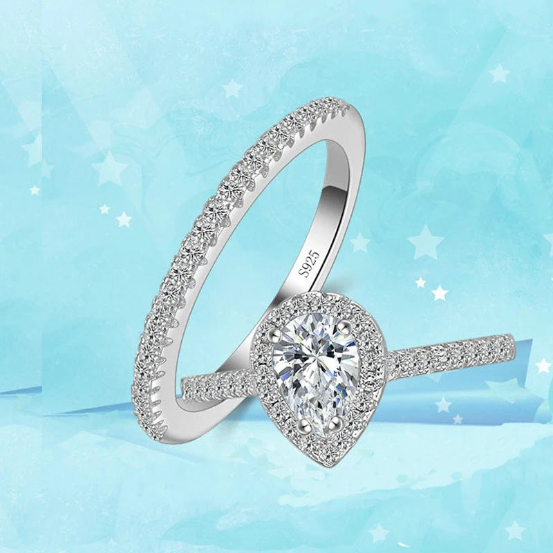 Silver ring with a large diamond on a light blue background